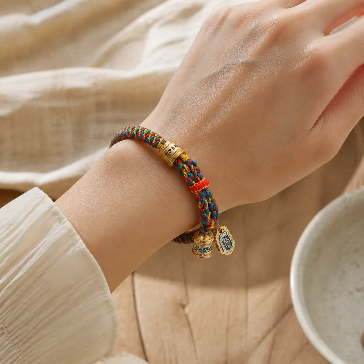 Tibetan Om Mani Padme Hum bracelet worn on a woman's wrist