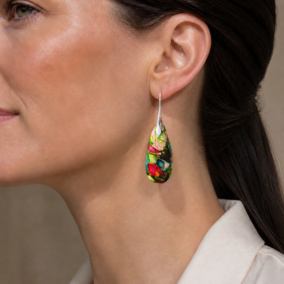 Emperor Stone teardrop earring worn by a woman