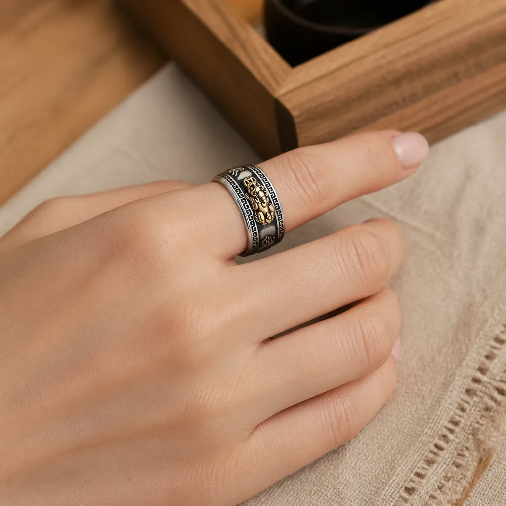 Feng Shui PiXiu wealth ring worn on a woman's hand