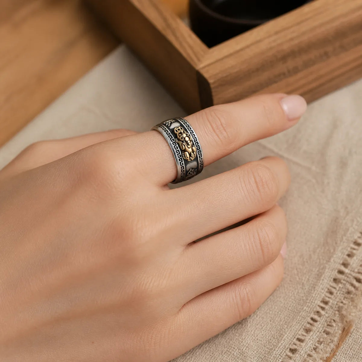 Feng Shui PiXiu wealth ring worn on a woman's hand